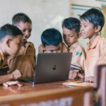 Primary school students learning together on a laptop in a digital literacy programme