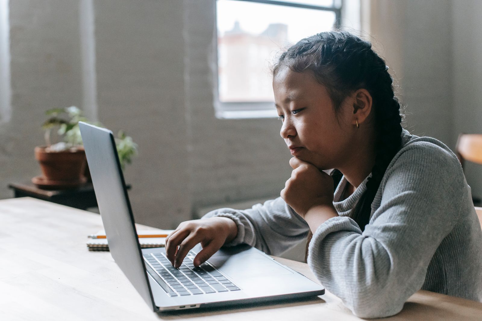 Young student completing a laptop assignment as part of the digital literacy programme