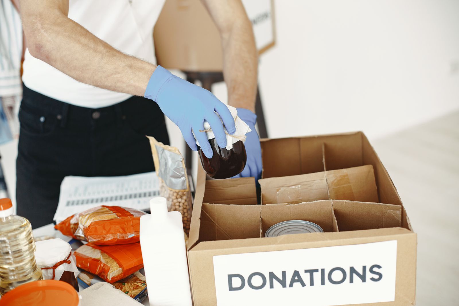 Volunteer packing basic food packages for community distribution